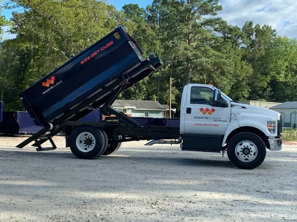 waste cubes truck and dumpster unloading