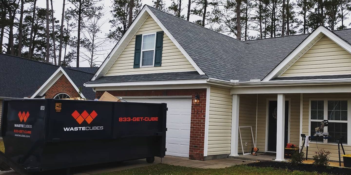 wastecubes dumpster in front of a house